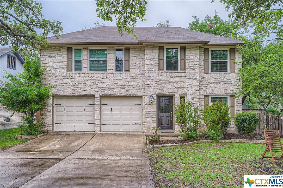 7410 Napier Trail Austin, TX 78729 - Photo 1 of 1 a front view of a house with a garden
