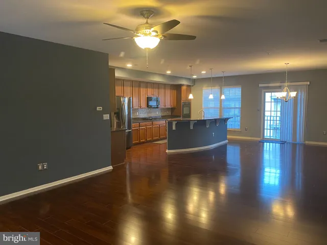 a view of a living room and kitchen with wooden floor