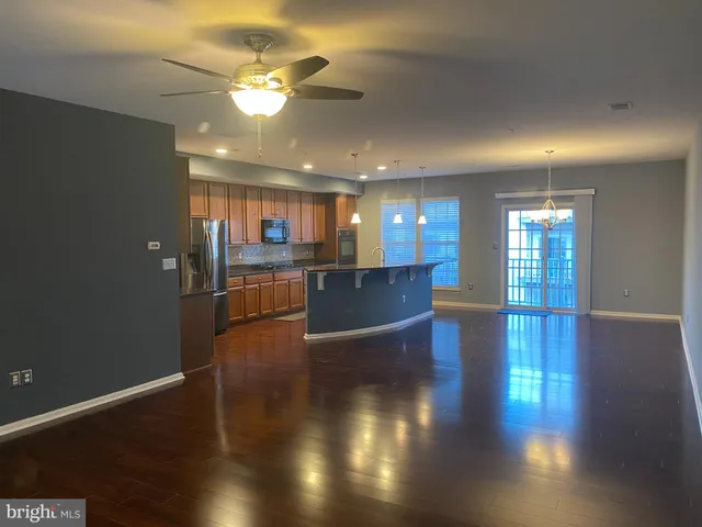 a view of a kitchen with a sink and a refrigerator