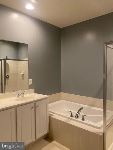 a bathroom with a shower and a glass door