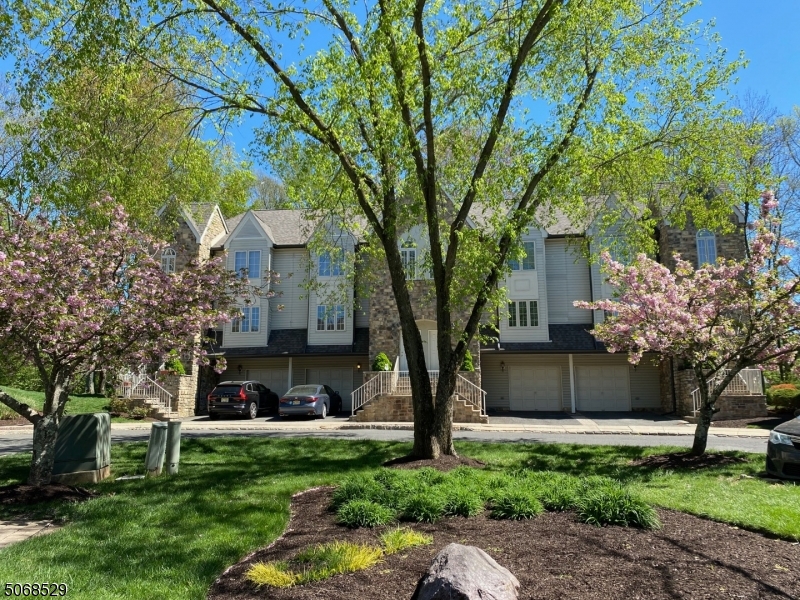 15 Starling Way Berkeley Heights, NJ 07922 - Photo 1 of 21 a front view of a house with a garden and trees