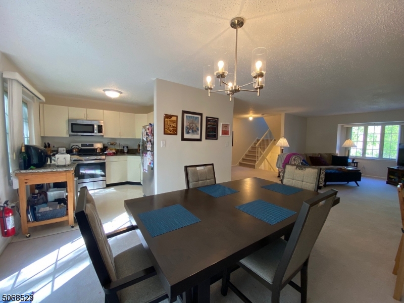 15 Starling Way Berkeley Heights, NJ 07922 - Photo 15 of 21 a view of a dining room and a kitchen with a table chairs