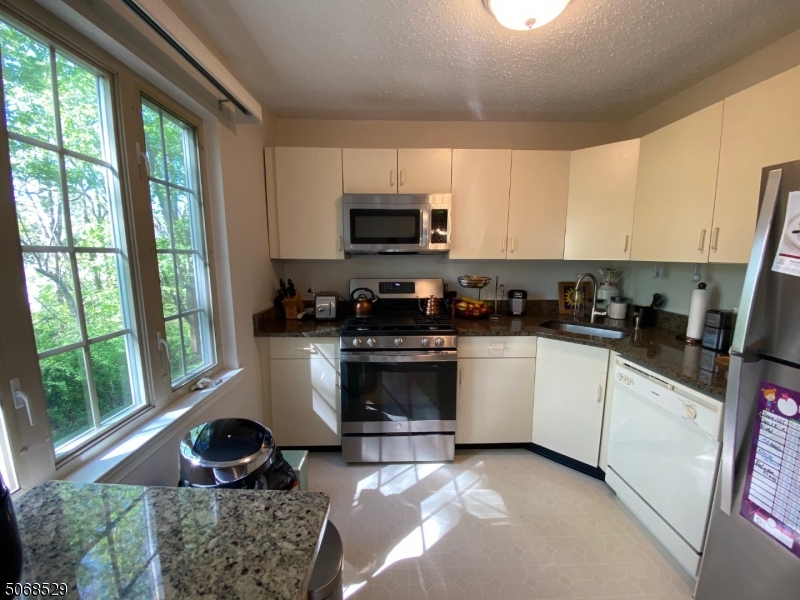 15 Starling Way Berkeley Heights, NJ 07922 - Photo 3 of 21 a kitchen with a stove a sink and a microwave
