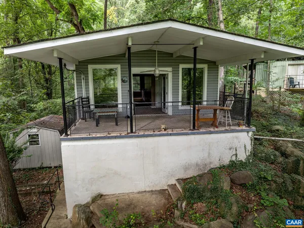 a view of a house with backyard and porch