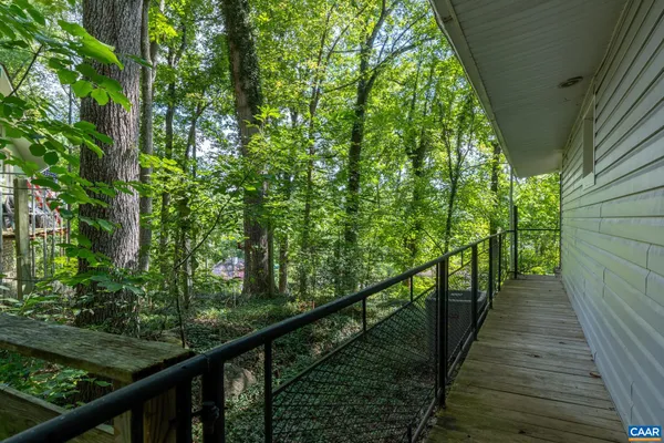 a view of a wooden balcony and trees