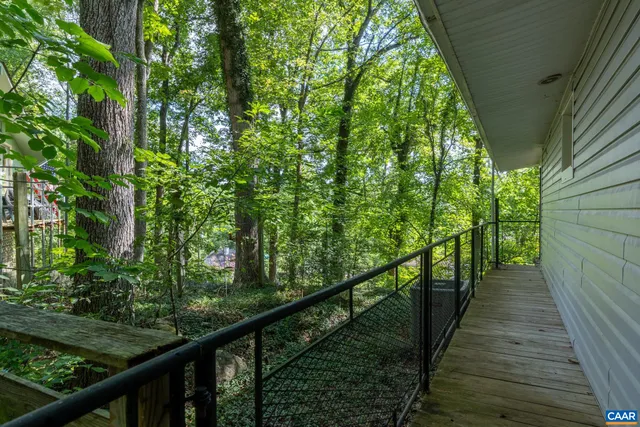 a view of a wooden balcony and trees