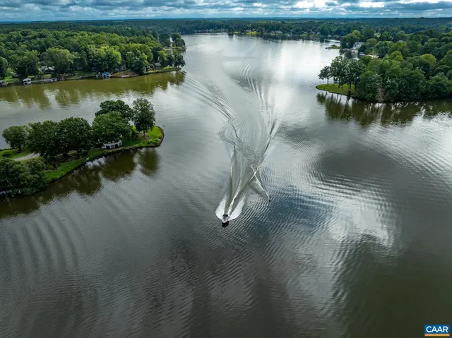 an aerial view of a house with outdoor space lake view and lake view