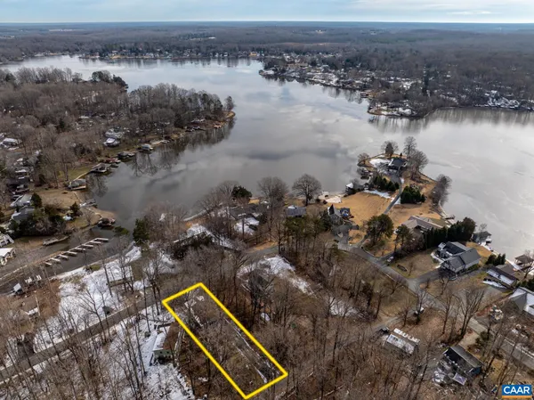 an aerial view of a house with a lake view