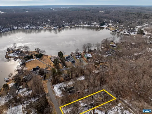 an aerial view of a house with a lake view and mountain view