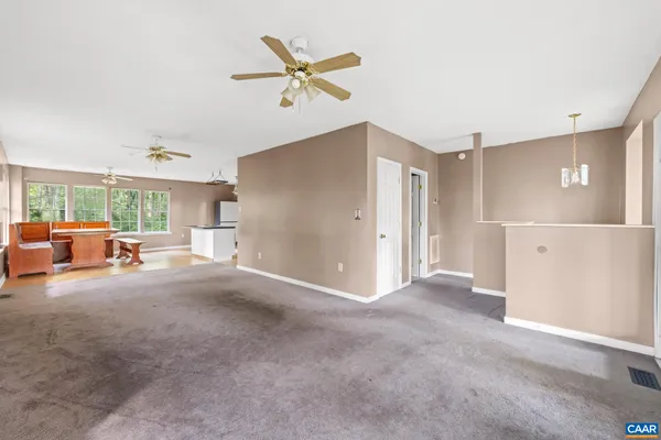 a view of a livingroom with furniture and a ceiling fan