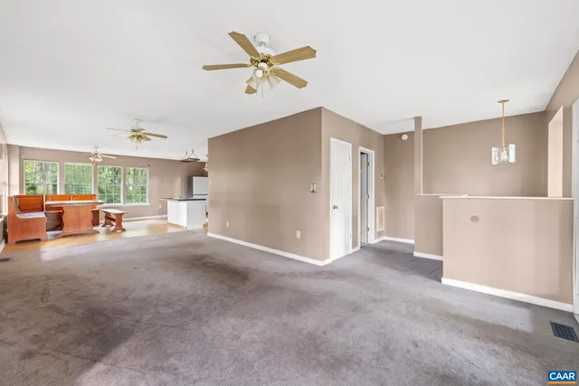 a view of a livingroom with furniture and a ceiling fan