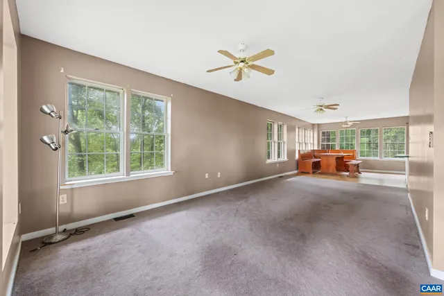 a room with a window and ceiling fan