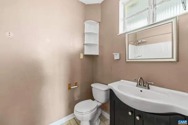 a white toilet sitting next to a bathroom sink