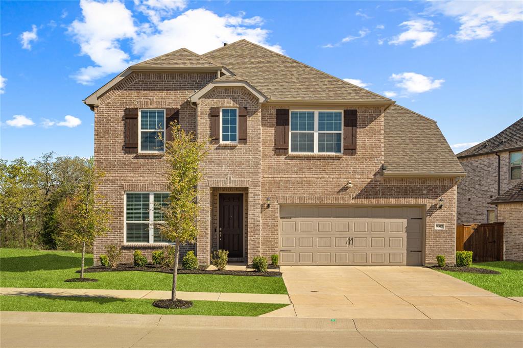 9517 Sunset Lane Oak Point, TX 75068 - Photo 2 of 40 9517 Sunset Lane, Oak Point, TX 75068 - Front of home - View of front facade with a shingled roof, brick siding, driveway, and an attached garage