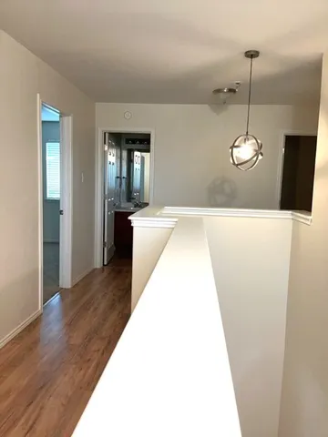 a en suite bathroom with a sink and wooden floor