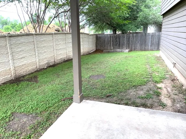 a backyard of a house with table and chairs