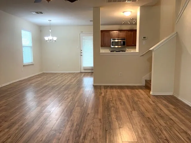a view of a room with wooden floor