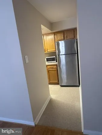 a view of a kitchen with wooden floor and electronic appliances