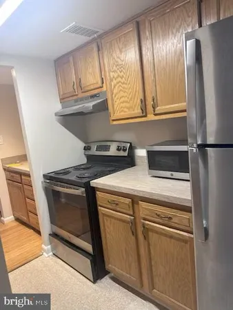 a refrigerator freezer sitting inside of a kitchen