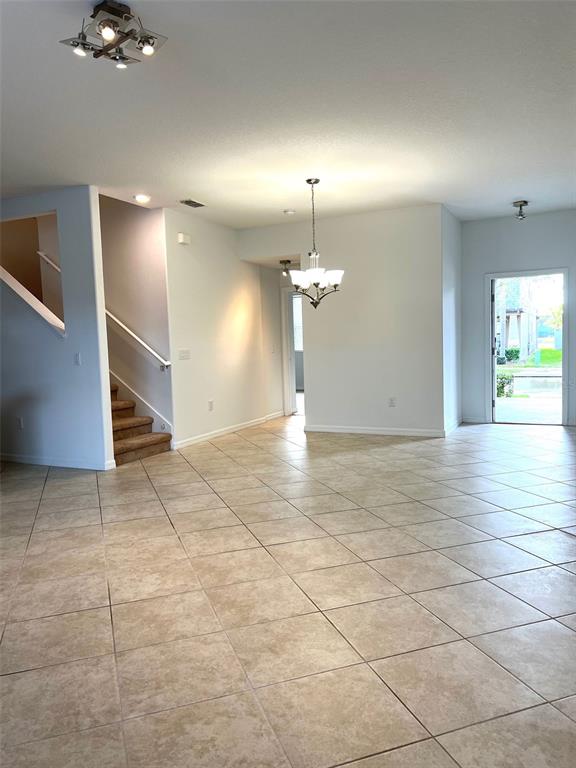 7681 Fordson Lane Windermere, FL 34786 - Photo 3 of 17 an empty room with chandelier fan and windows