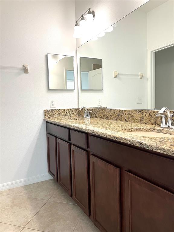7681 Fordson Lane Windermere, FL 34786 - Photo 7 of 17 a bathroom with a granite countertop sink and a mirror