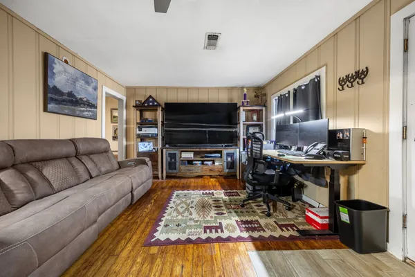 a living room with furniture and a flat screen tv