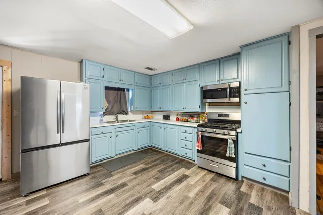 a kitchen with a refrigerator stove and microwave