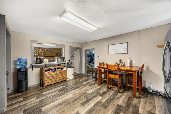 a view of a dining room with furniture and wooden floor