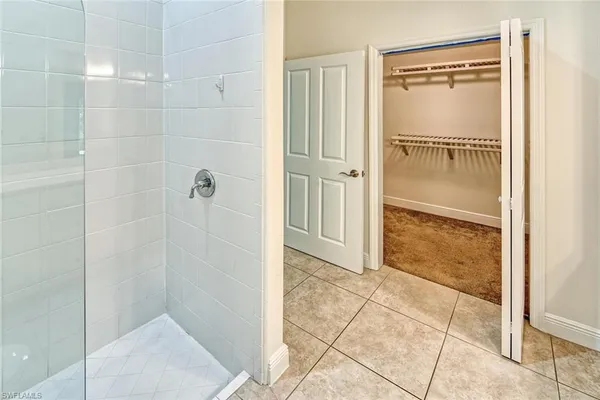 a bathroom with a glass shower door