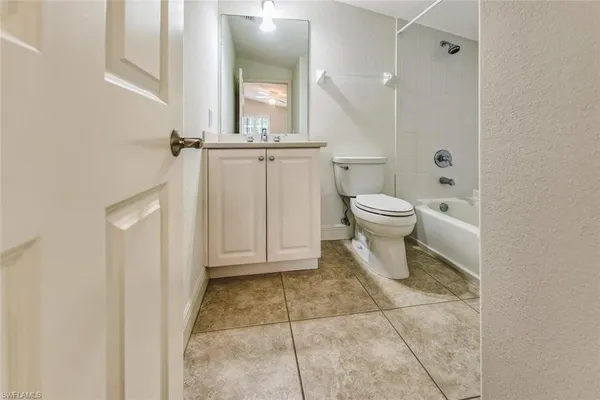 a bathroom with a toilet a sink and shower