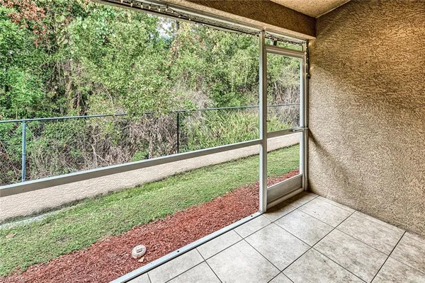 a view of a room with a large window and a porch