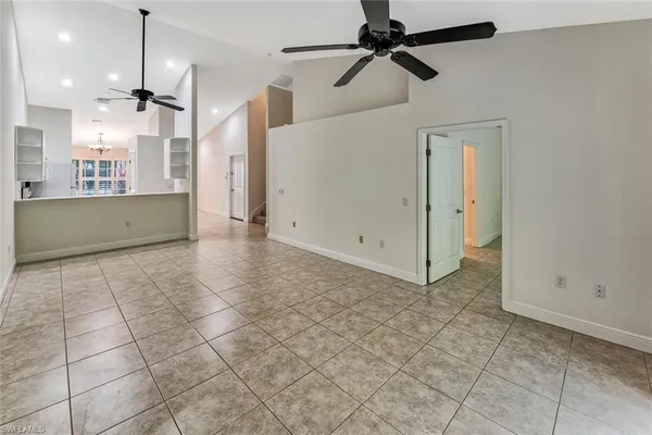 a view of a kitchen with a sink and a refrigerator