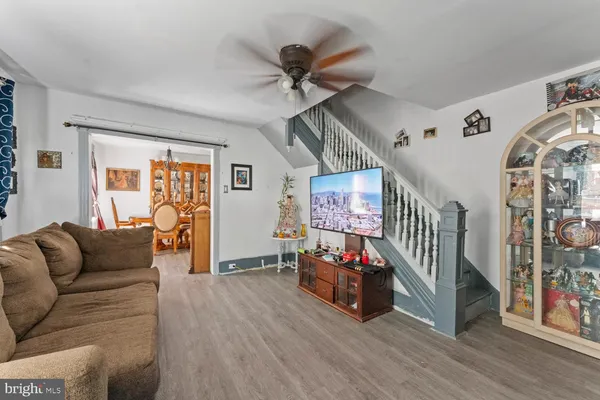 a living room with furniture and wooden floor