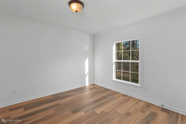 a view of a room with wooden floor and window