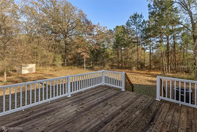 a view of balcony with wooden floor and fence