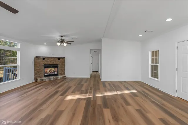 a view of a kitchen with wooden floor and a ceiling fan