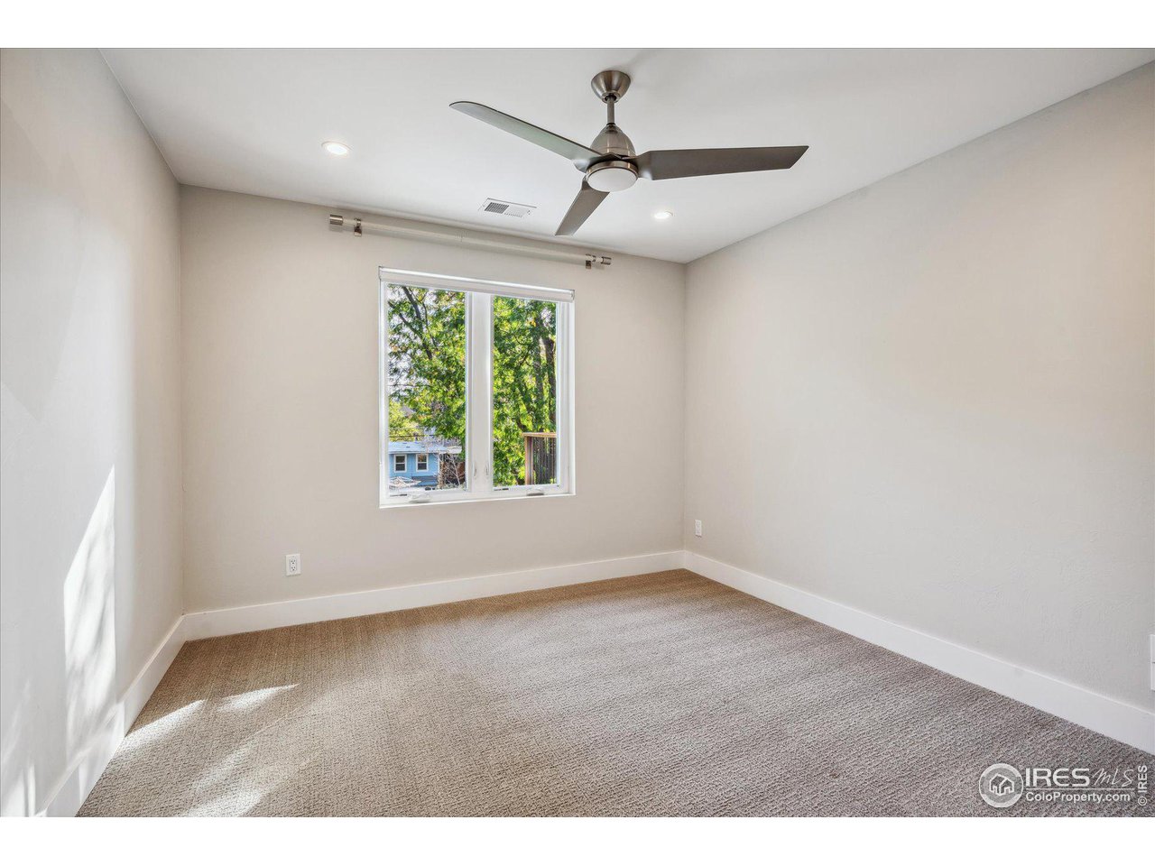 1920 Vista Drive Boulder, CO 80304 - Photo 24 of 38 an empty room with wooden floor ceiling fan and windows