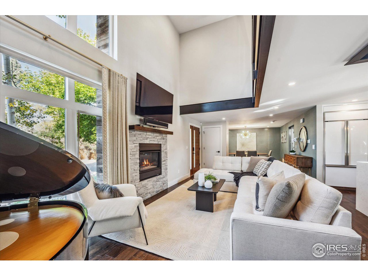 1920 Vista Drive Boulder, CO 80304 - Photo 5 of 38 a living room with furniture a flat screen tv and a fireplace