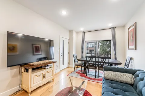 a living room with furniture cabinets and a flat screen tv