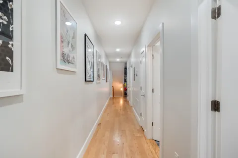 a view of a hallway with wooden floor