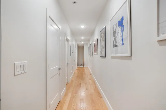 a view of a hallway with wooden floor