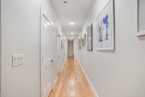a view of a hallway with wooden floor