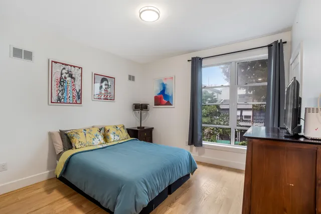 a bedroom with a large bed and a large window
