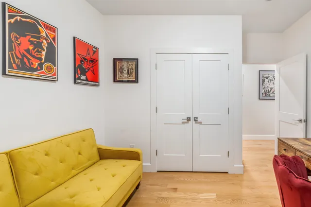a view of a bedroom with furniture and wooden floor