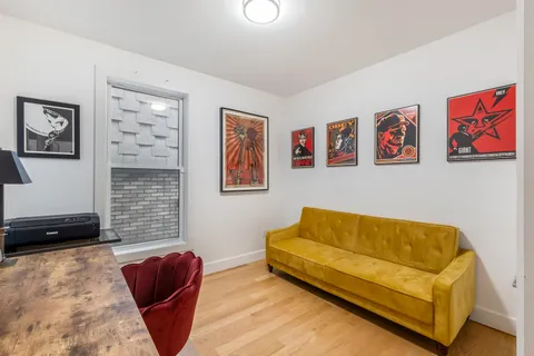 a blue couch sitting in a living room next to a lamp