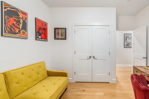 a view of a bedroom with furniture and wooden floor