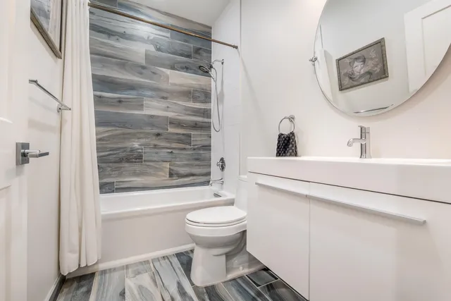 a bathroom with a sink toilet and shower