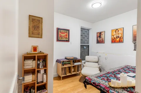 a bedroom with furniture and a baby crib