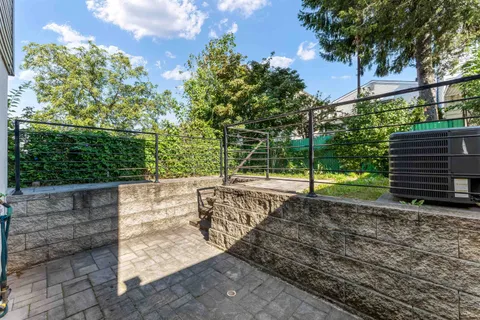 a view of a yard with wooden fence
