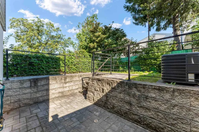 a view of a yard with wooden fence
